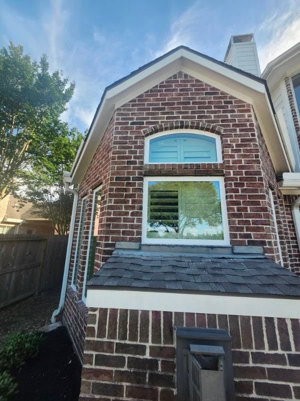 Custom arched window on brick home
