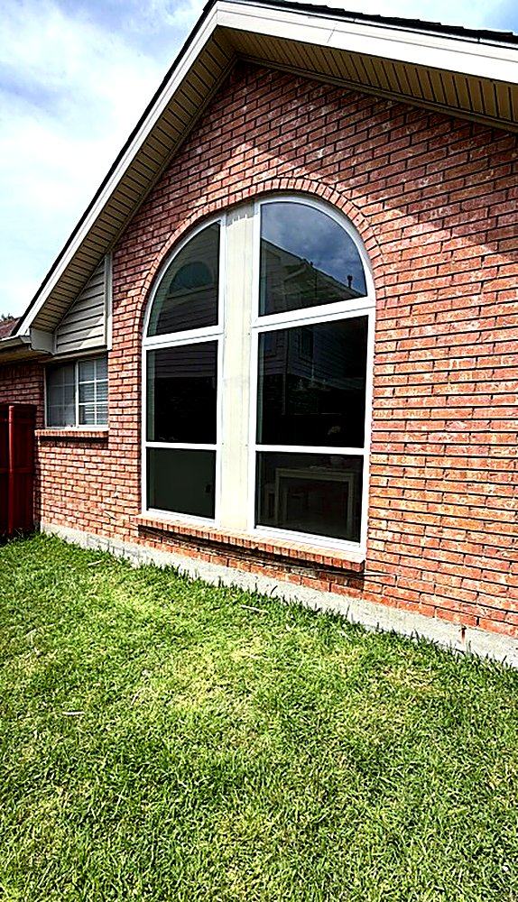 Custom arched picture window on a Houston brick home